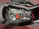 a bag with tools inside of it on the floor