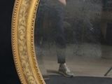 a mirror that has a reflection of a person in it