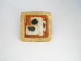 a brown and black square shaped object on a white surface