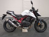 a picture of a white and red motorcycle parked in a garage