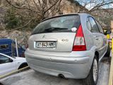 a silver car that is parked on the side of the road