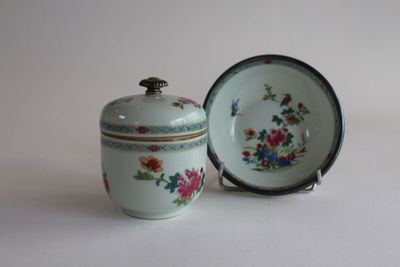 a small cup and saucer sitting on a table