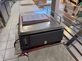 a microwave sitting on top of a counter in a store