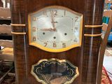 a clock that is sitting on a chair in a room