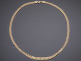 a gold chain necklace with a clasp on a black background