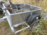 a trailer with a trailer attached to it in the grass
