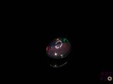 an image of an apple in the dark with a black background