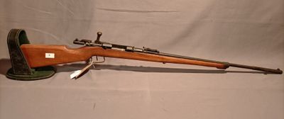 an old rifle with a wooden barrel and a green case