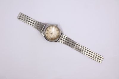 a close up of a wrist watch on a white surface