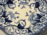 a blue and white plate with blue flowers on it