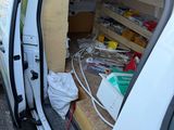 a white van that has a bunch of items in it