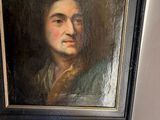 a painting of a man that is hanging on the wall
