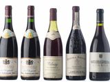 several bottles of wine are lined up on a white surface