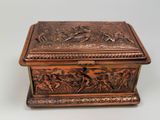 an antique bronze box with a scene on it on a table