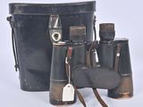 a black bucket with a pair of binoculars next to it