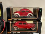two red and white model cars sitting next to each other on a table