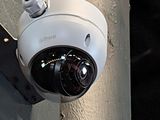 an image of a security camera attached to the side of a building