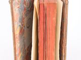 an open book that is sitting on a white surface