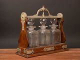 a wooden table with four glass bottles on it