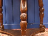 a wooden table with carvings on the top of it