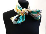 yellow and blue floral bow tie on a mannequin neck