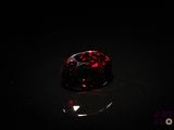 a close up of a red diamond on a black surface
