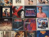 many movie posters on the wall of a room