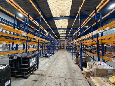 a large warehouse filled with lots of shelves and pallets