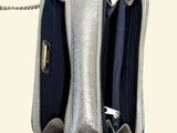 a silver purse with a chain hanging out of it