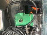 a green machine with a green handle and a black hose