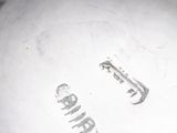 a close up of a silver plate with the word camper written on it