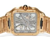 a close up of a gold watch with a black face