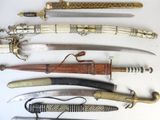 many different types of knives on display on a table