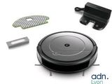 an image of a robotic vacuum cleaner and accessories on a white surface