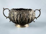 a silver bowl with a handle and handles on it