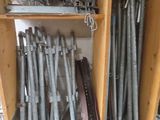 a lot of metal pipes that are stacked on a shelf