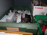 a green box filled with electronic equipment in a room