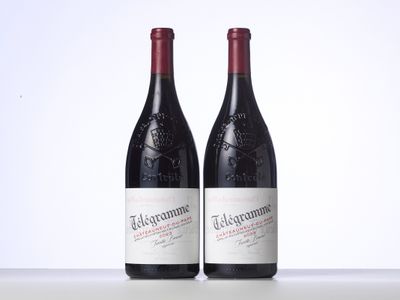 two bottles of red wine sitting next to each other on a table