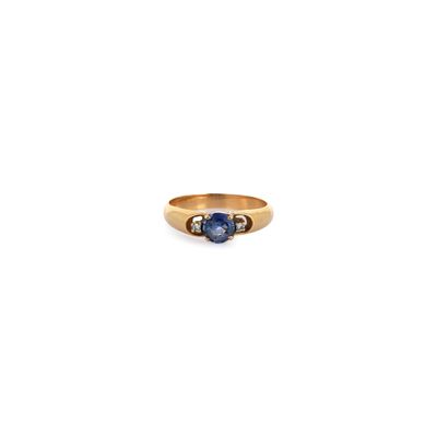 a close up of a gold ring with two sapphire stones
