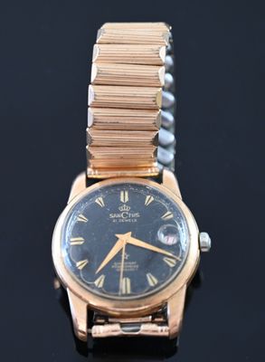 a close up of a wrist watch on a black surface