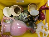 a yellow box with a bunch of vases in it