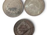 three different types of coins are shown on a white surface