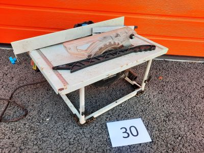 a small table with a saw on top of it