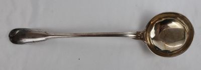 an antique silver spoon with a spoon handle on a white surface