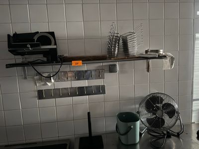 a kitchen with a fan, sink, and counter top