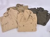 a pile of clothing sitting on a table next to a pair of gloves