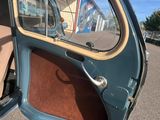 a small car with a door open in the parking lot
