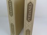two books sitting side by side on a white surface