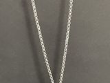 a white gold necklace with a diamond flower pendant on a chain