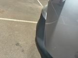 a parking meter on the side of the road next to a parked car